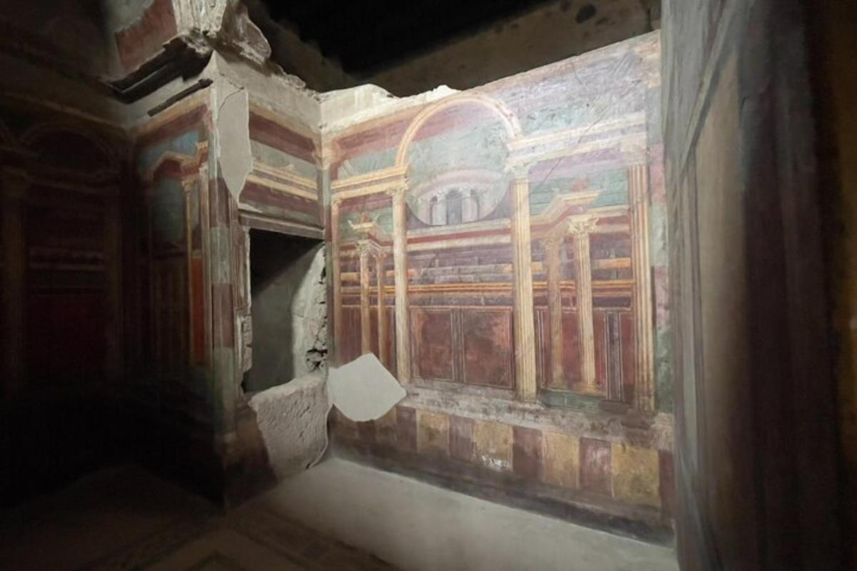 a room with a painting on the side of a wall