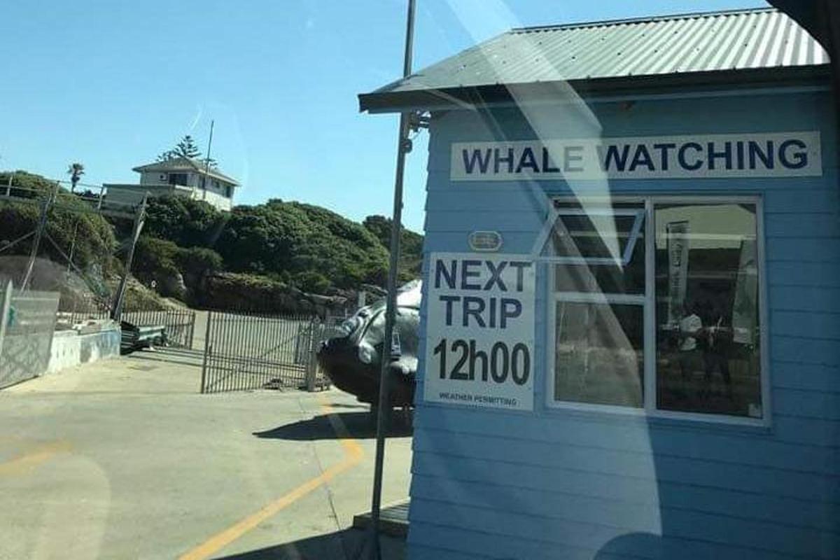 a building with a sign in a parking lot