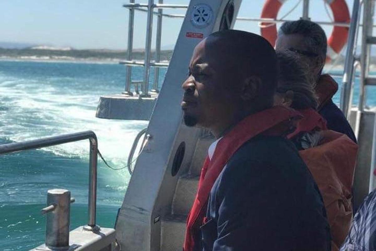 a man standing on a boat with a baby