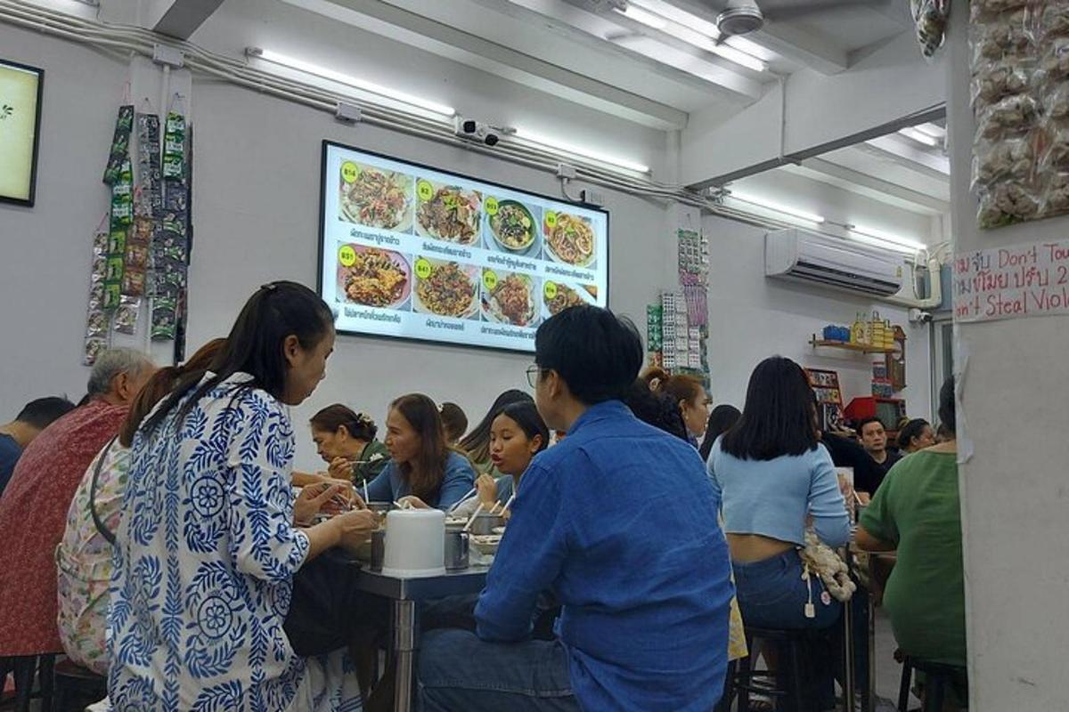 a group of people sitting at a table in a restaurant