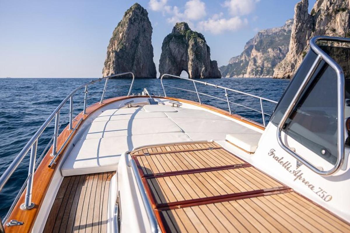 a boat in the ocean with mountains in the background