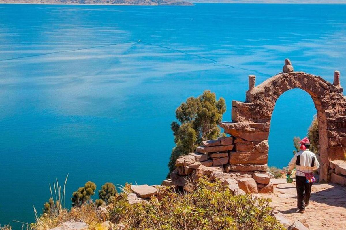 a man walking on the edge of a body of water