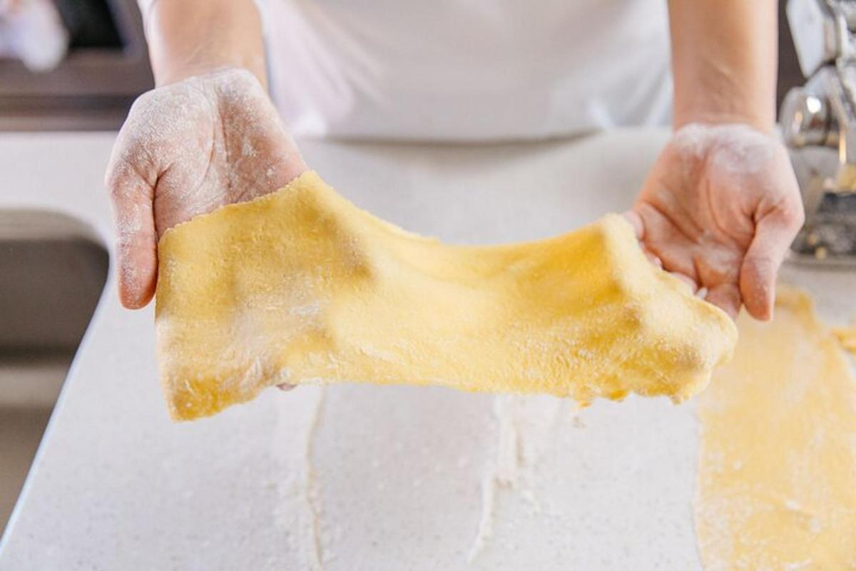 a person is holding a piece of dough