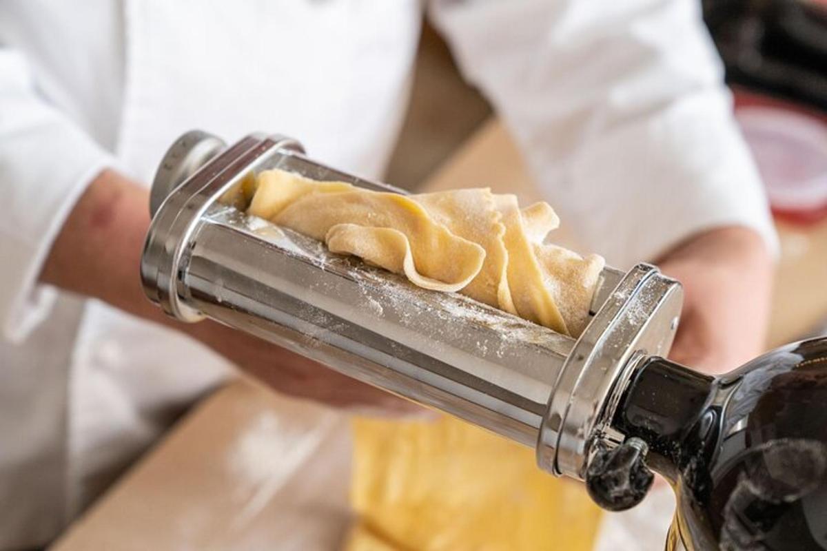 a person is holding a metal object with food