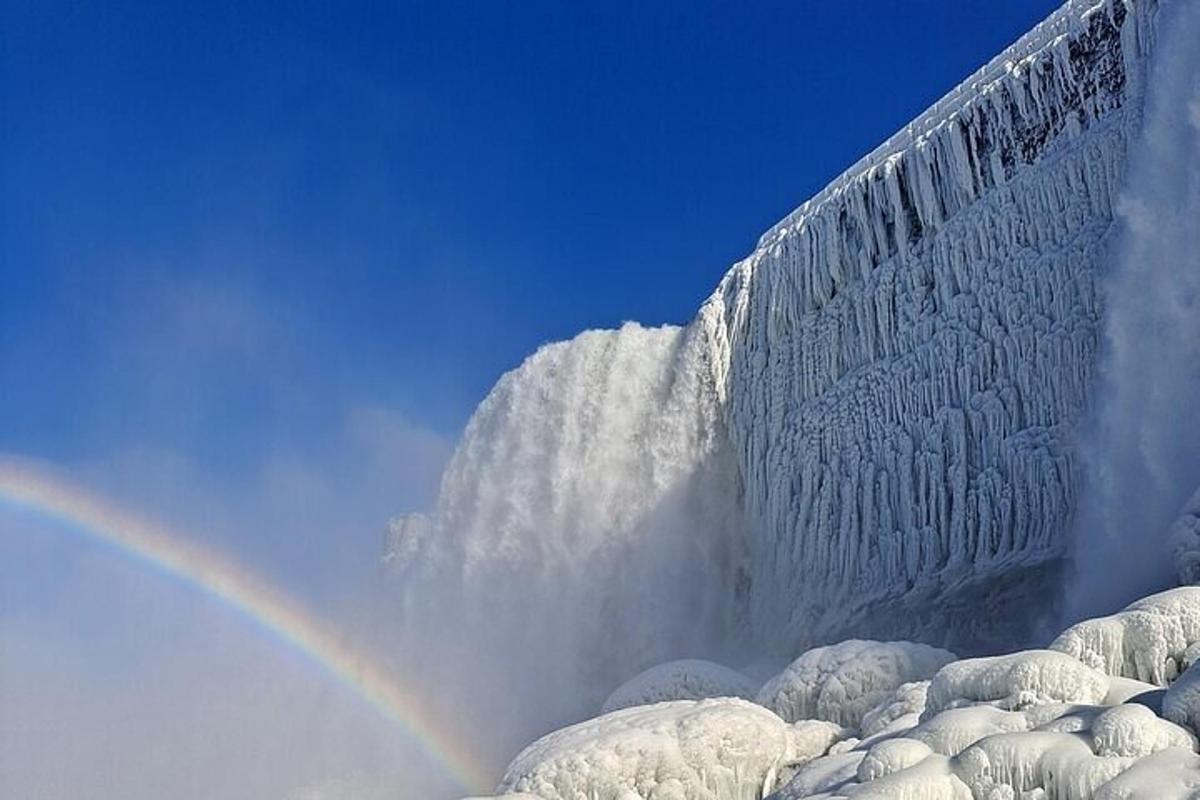 a rainbow in the sky with a ice wall