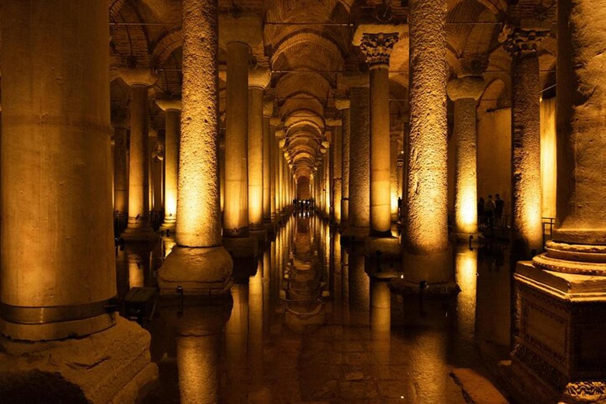 a hallway of a building with columns and water
