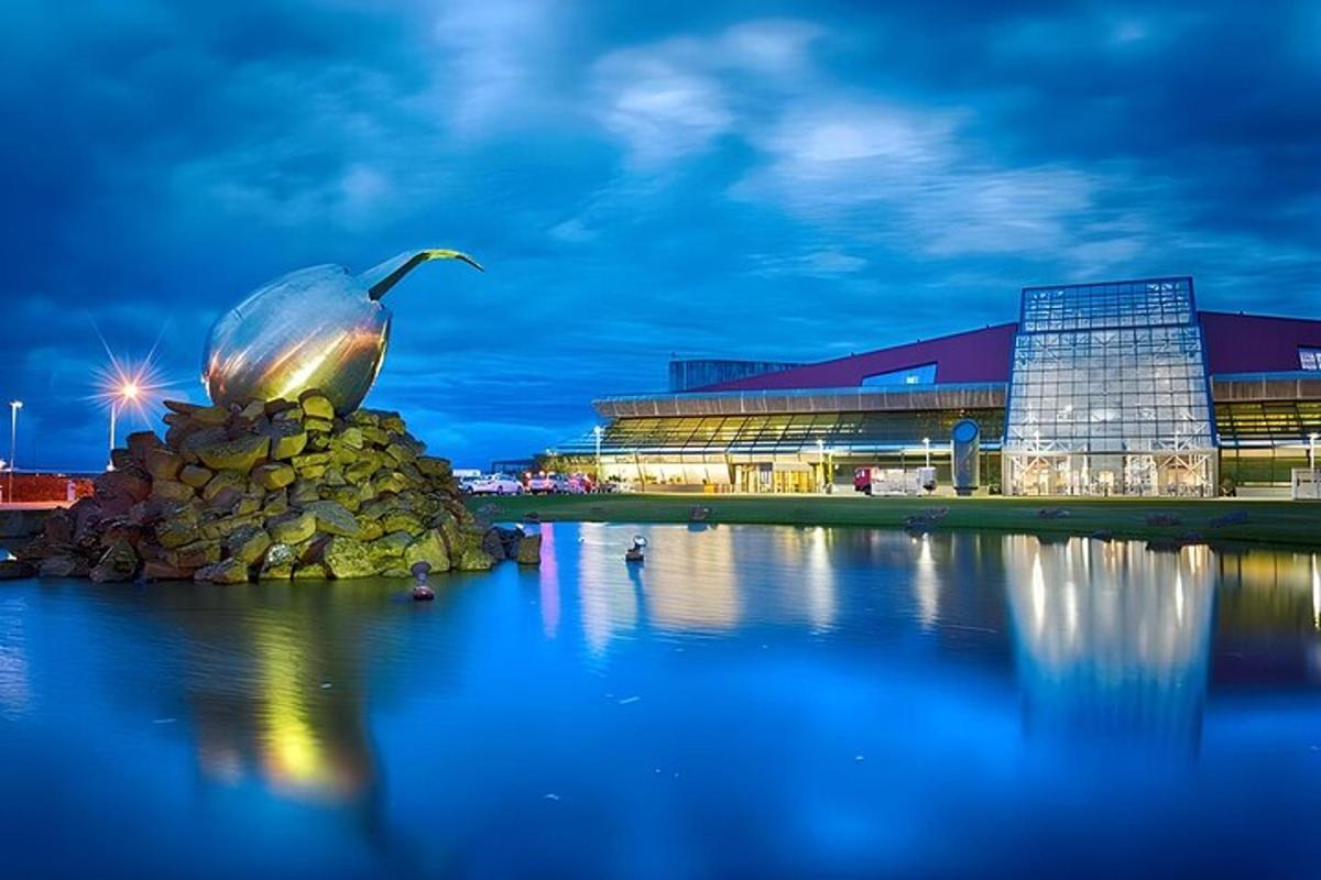 a building with a bird sitting on top of a rock in the water