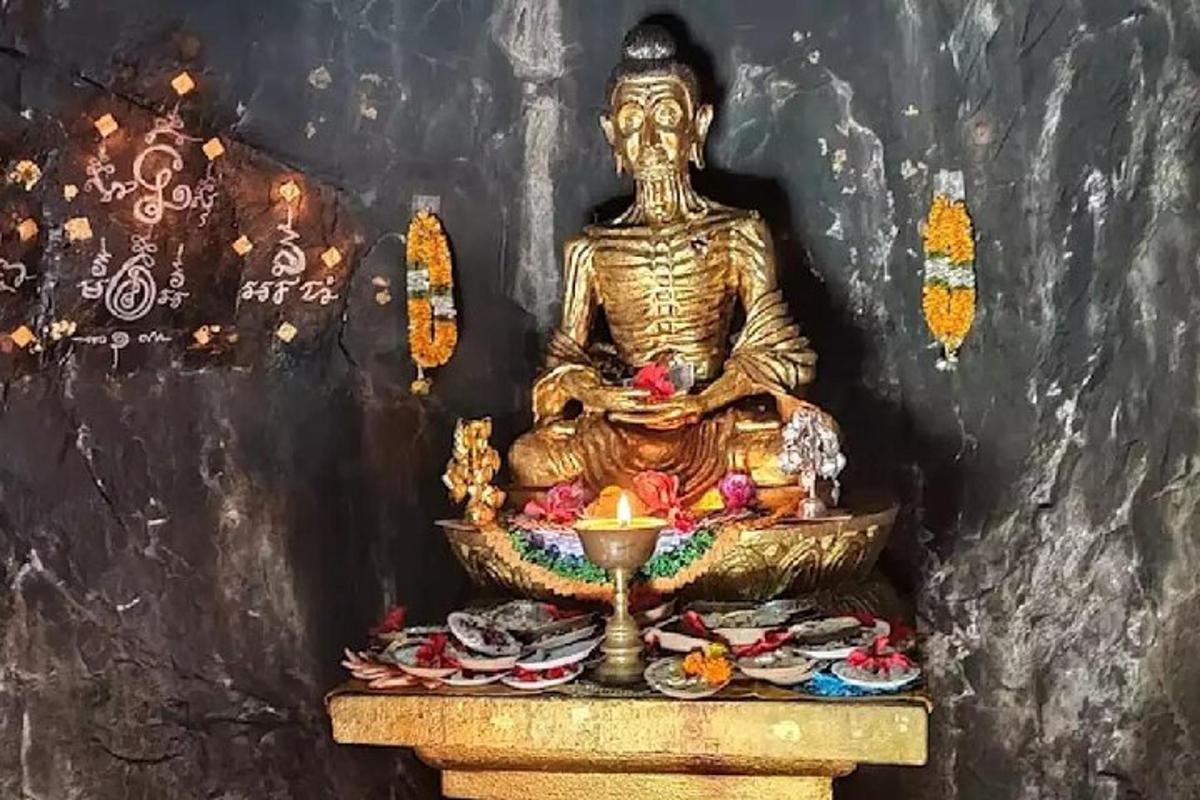 a statue of a deity sitting in a room