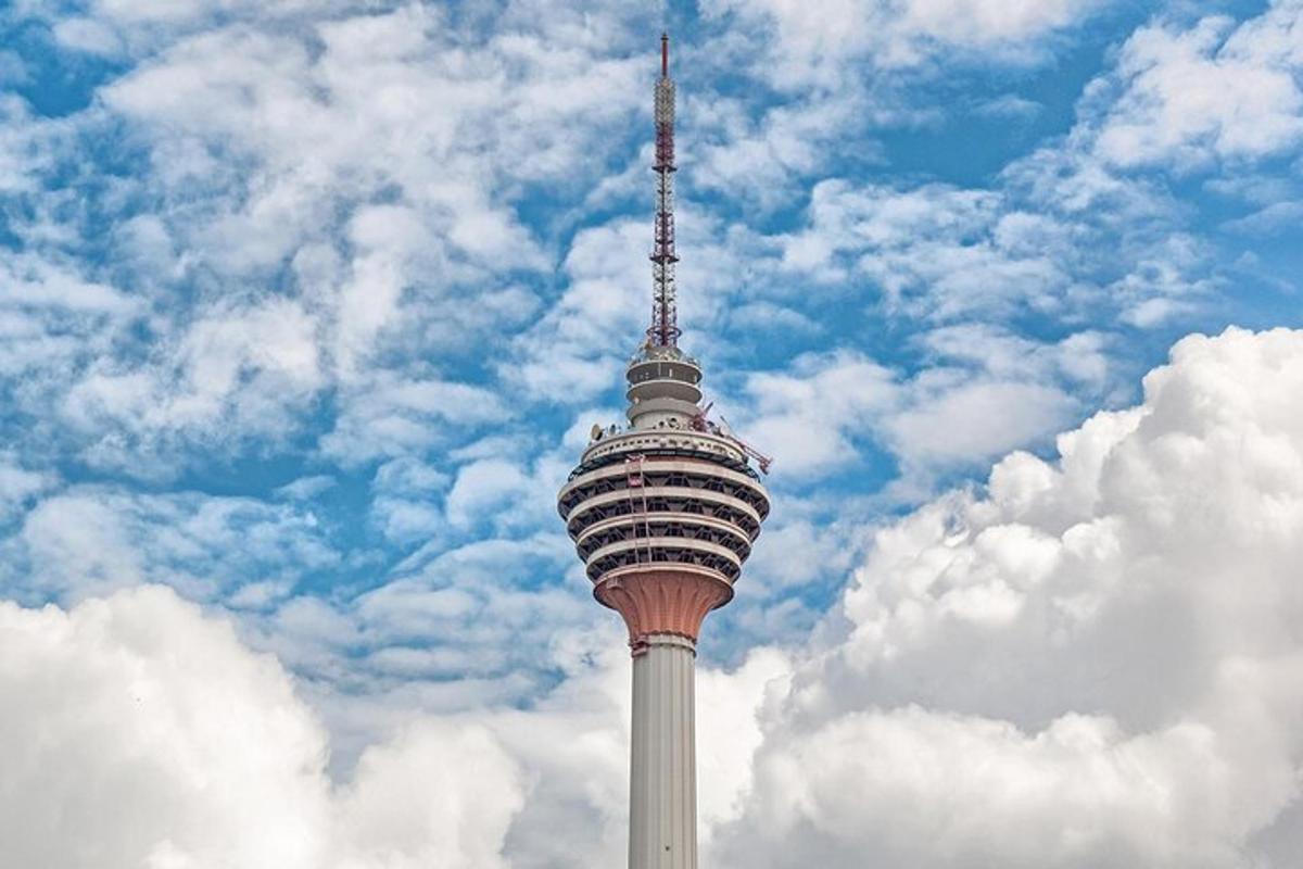 a tall observation tower with a cloudy sky in the background