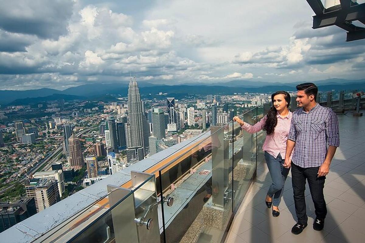 a man and a woman standing on top of a building
