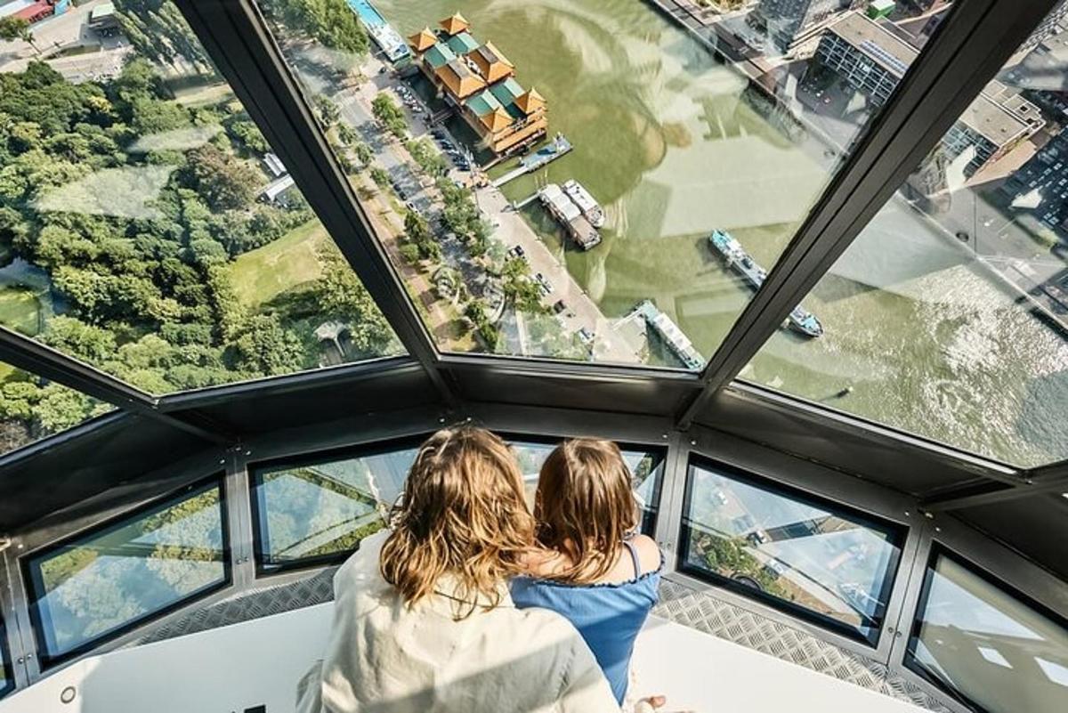 two people sitting on a chair in the top of an observation tower