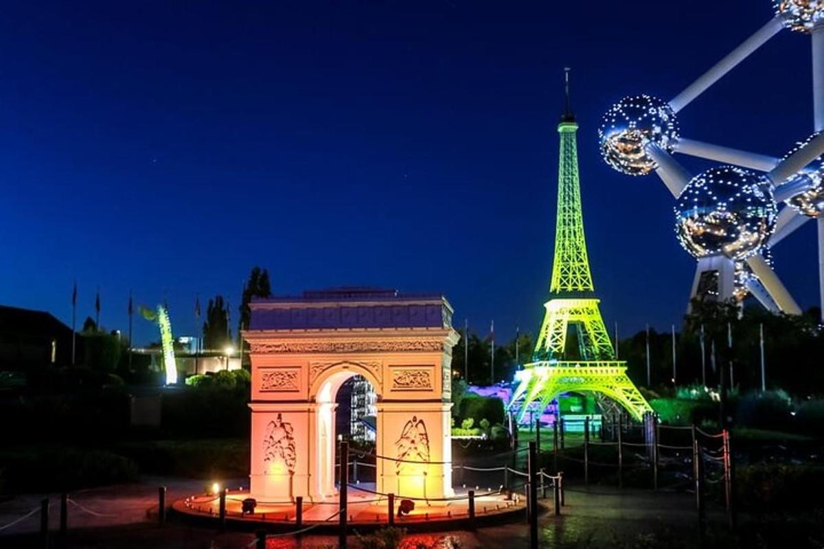 a monument in front of the eiffel tower at night