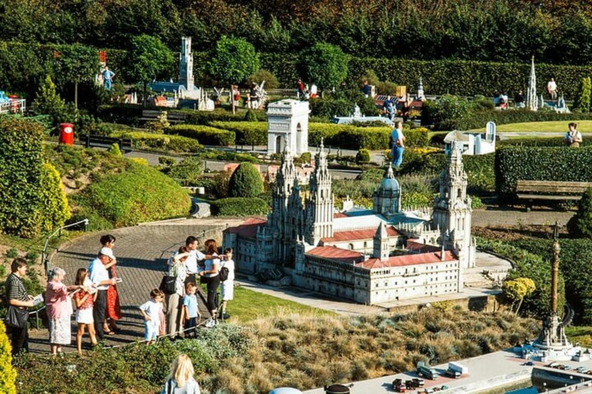 a group of people standing around a model of a castle