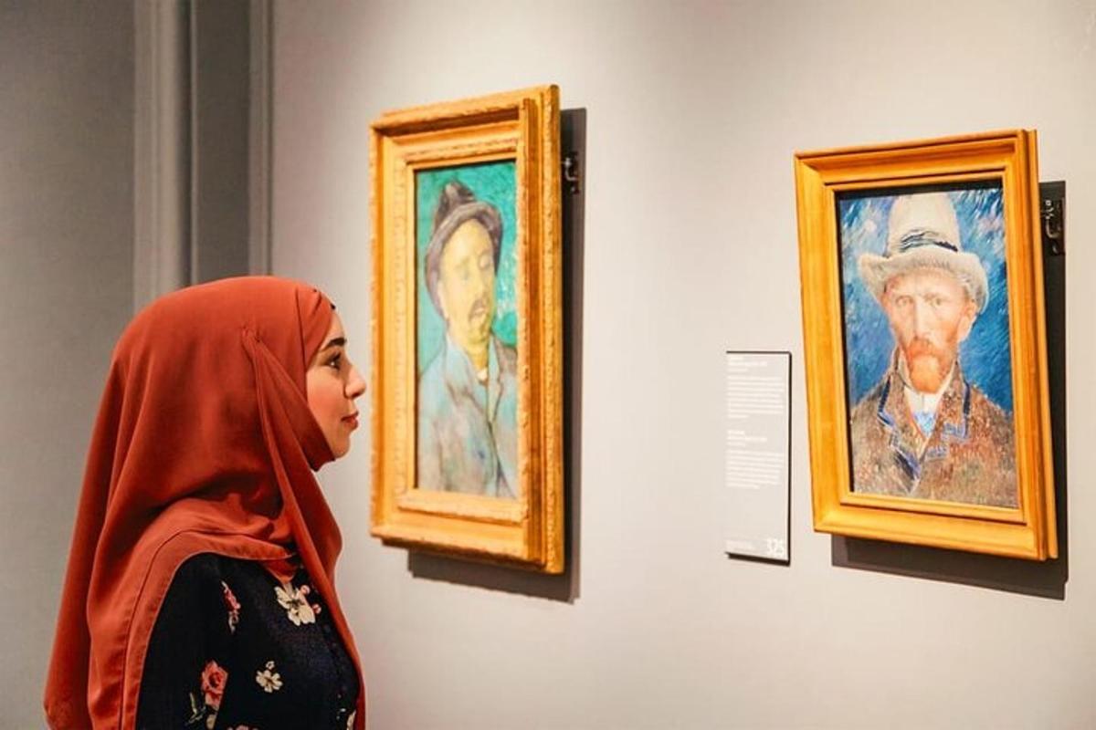 a woman looking at paintings on a wall