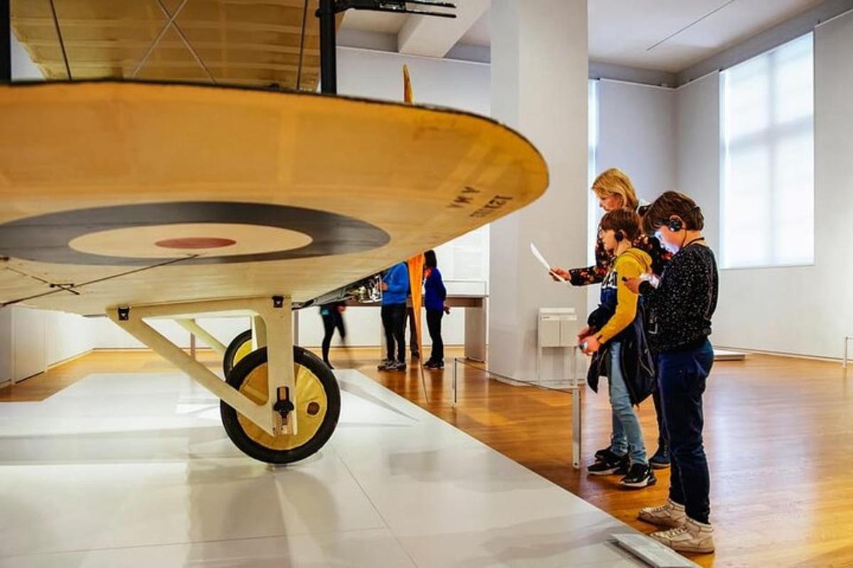 a group of children looking at an airplane in a museum