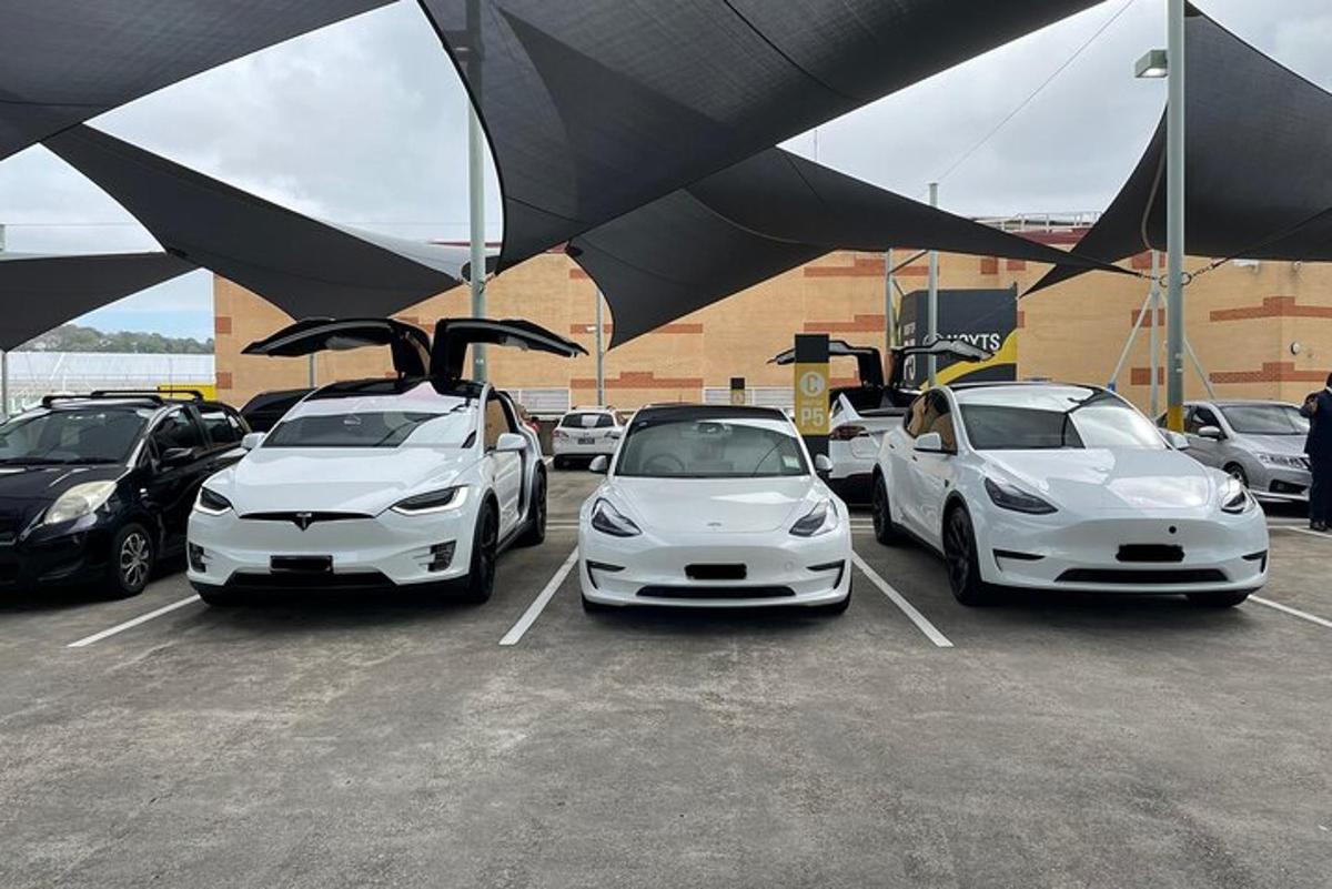 three white cars parked in a parking lot