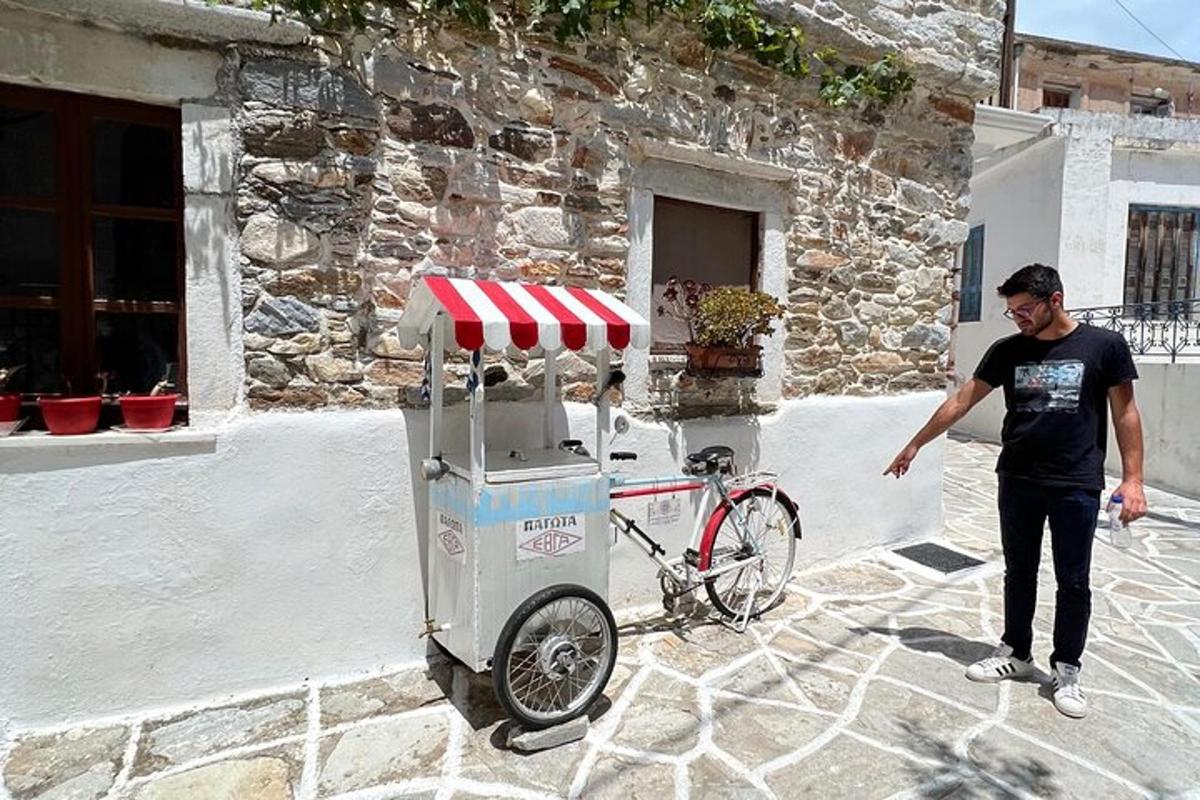 a man standing next to a bike parked next to a building