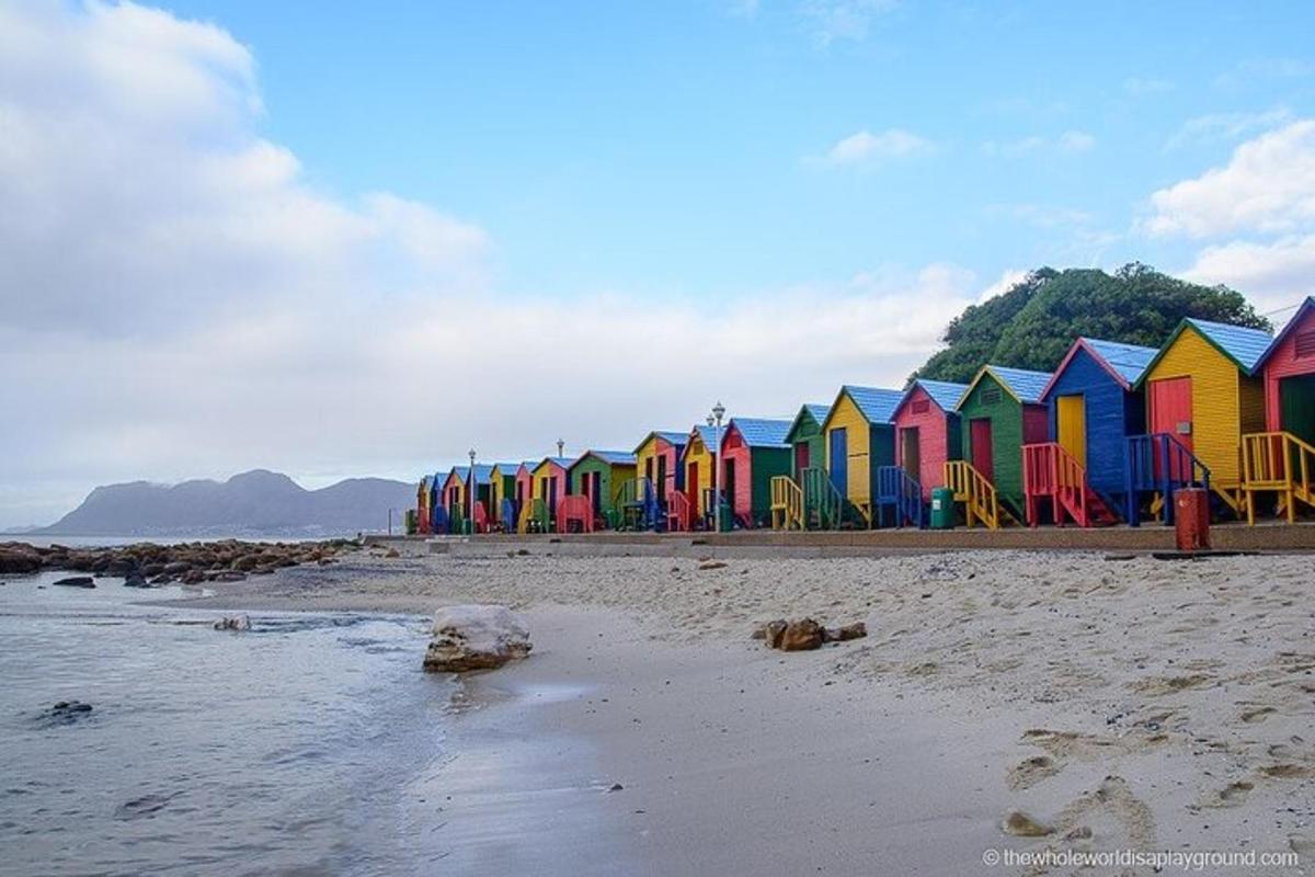 a row of colorful beach huts on a beach