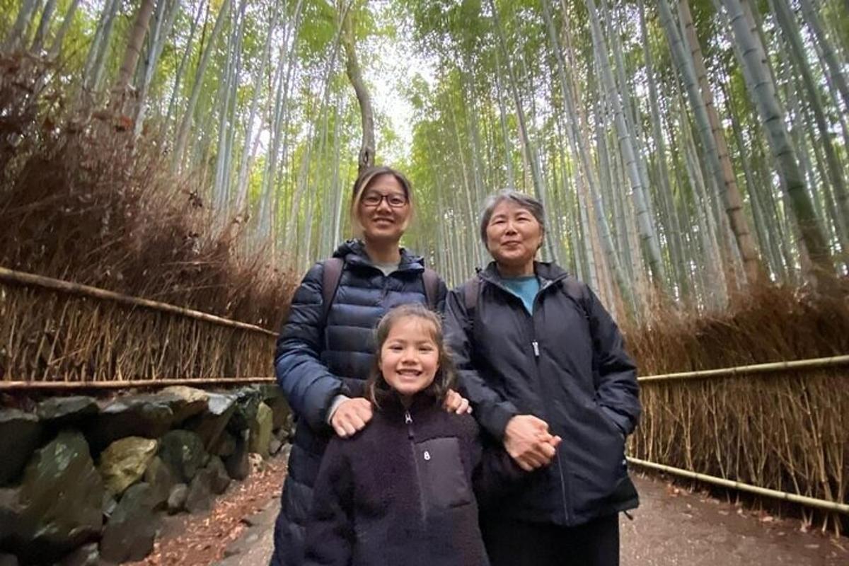 two women and a girl standing in a bamboo forest