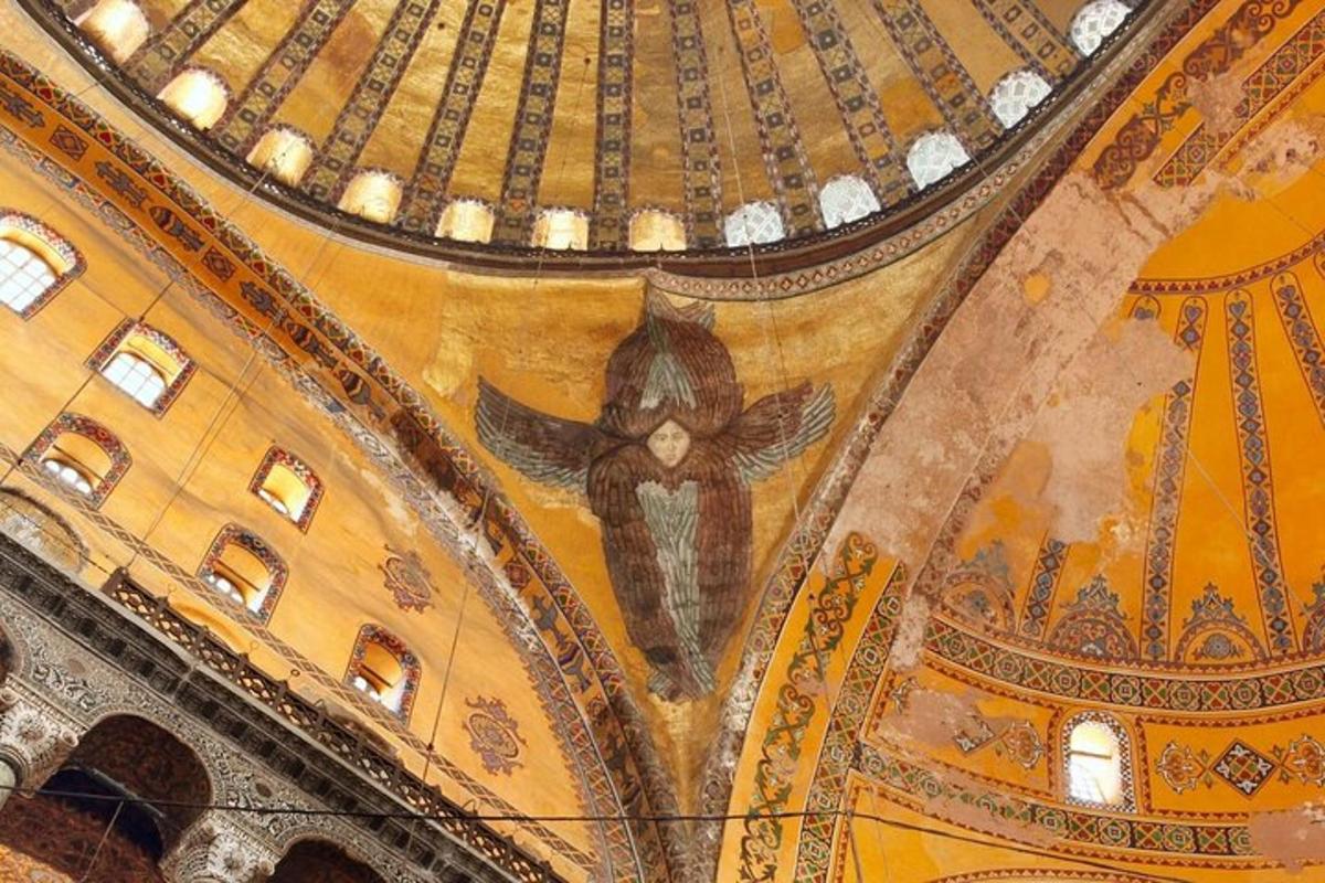 a ceiling of a building with a painting on it