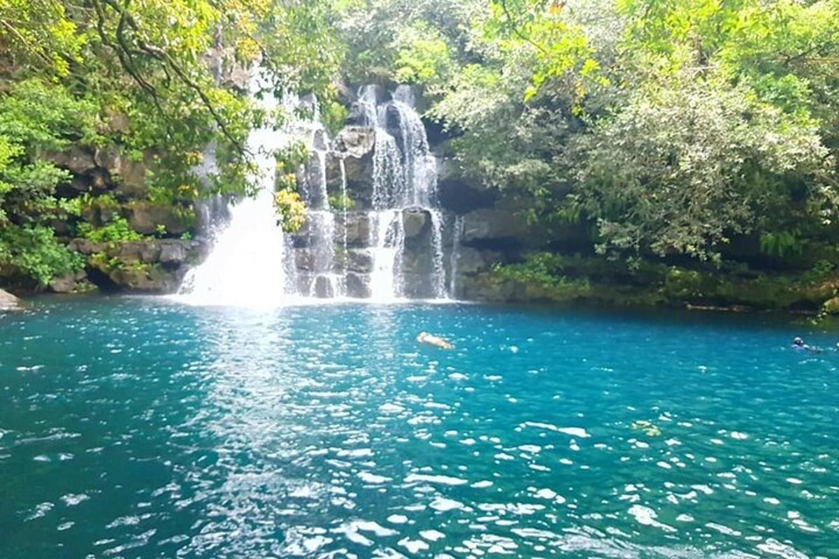 a waterfall in the middle of a pool of water