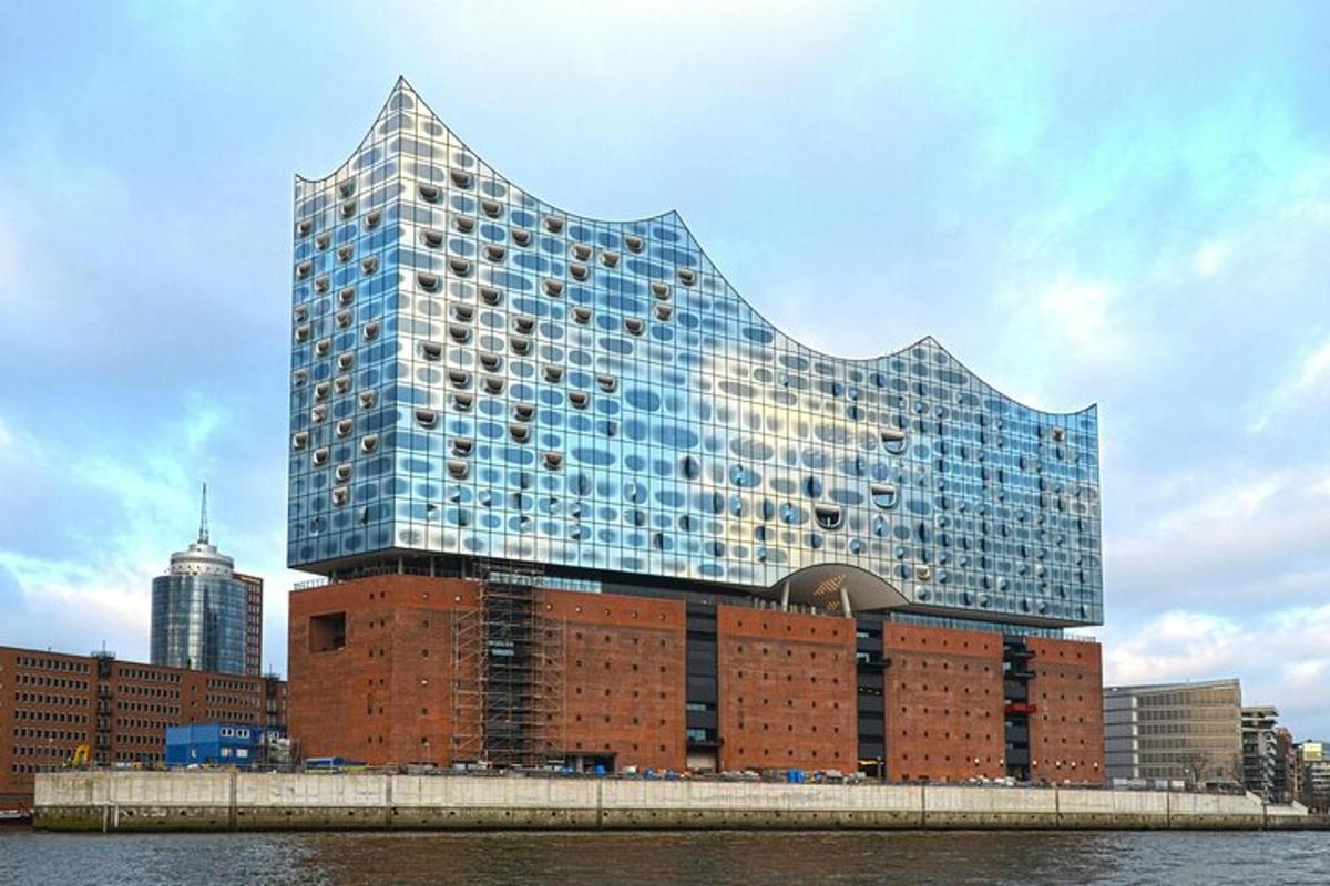 a tall glass building on top of a brick building