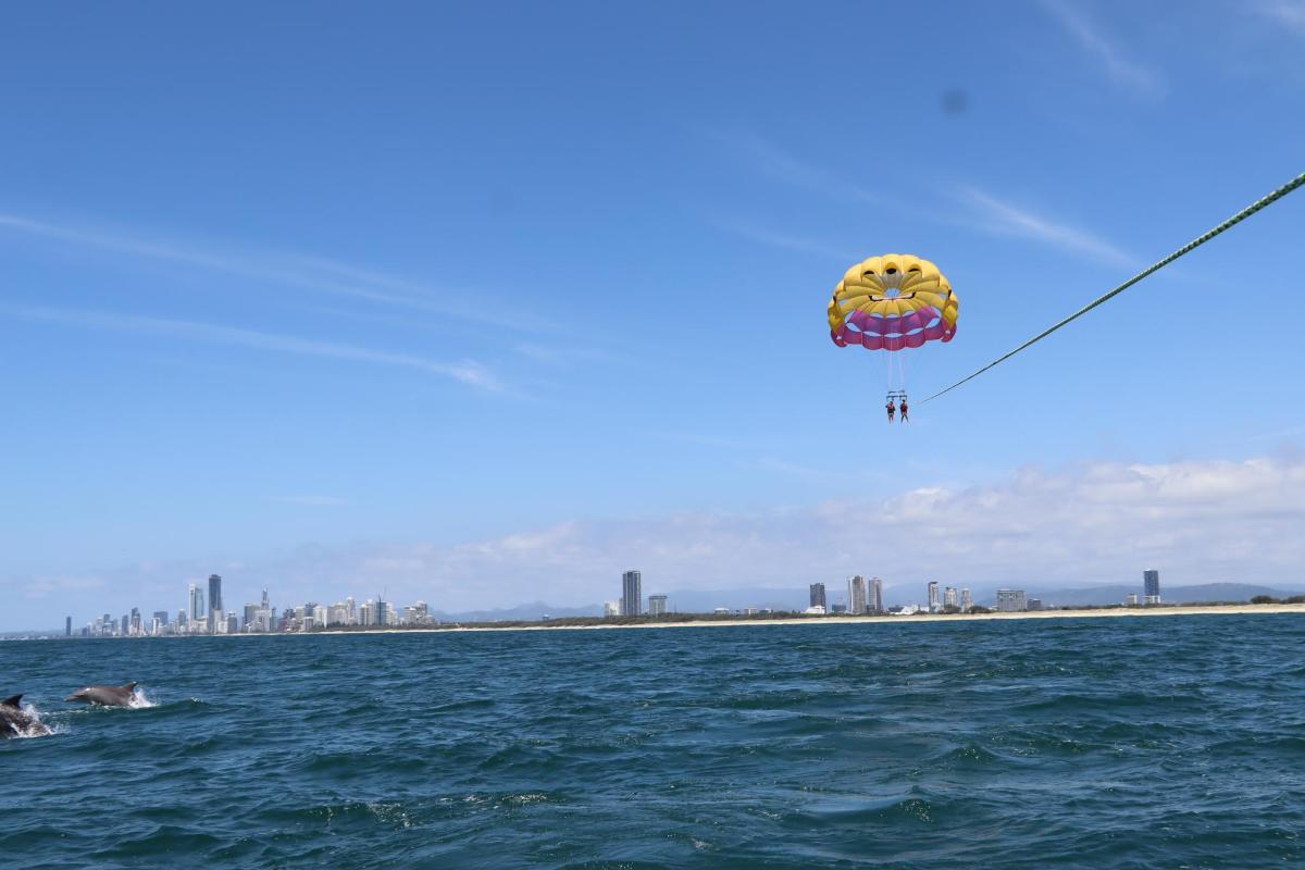 a kite flying in the sky over the water