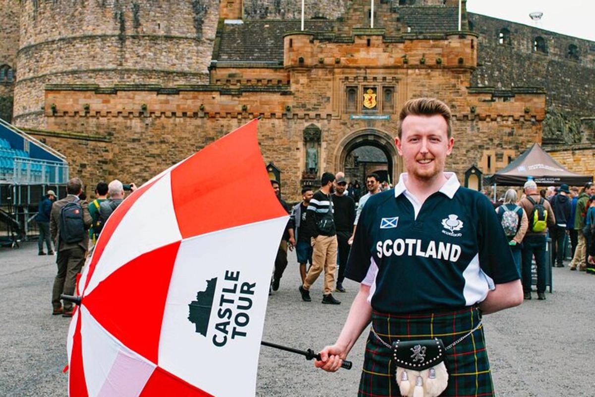 a man in a kilt holding an umbrella in front of a building