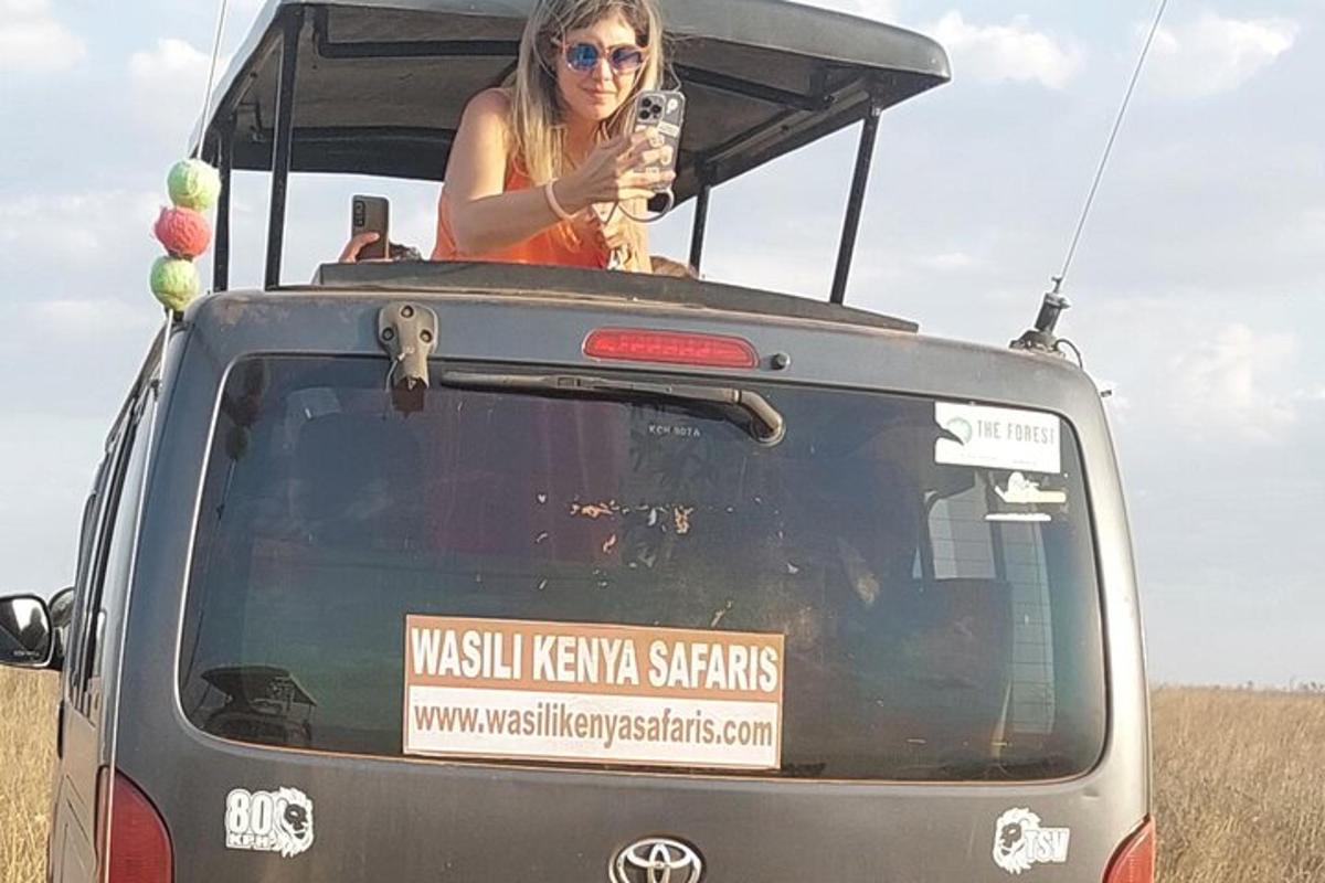 a woman standing in the back of a vehicle