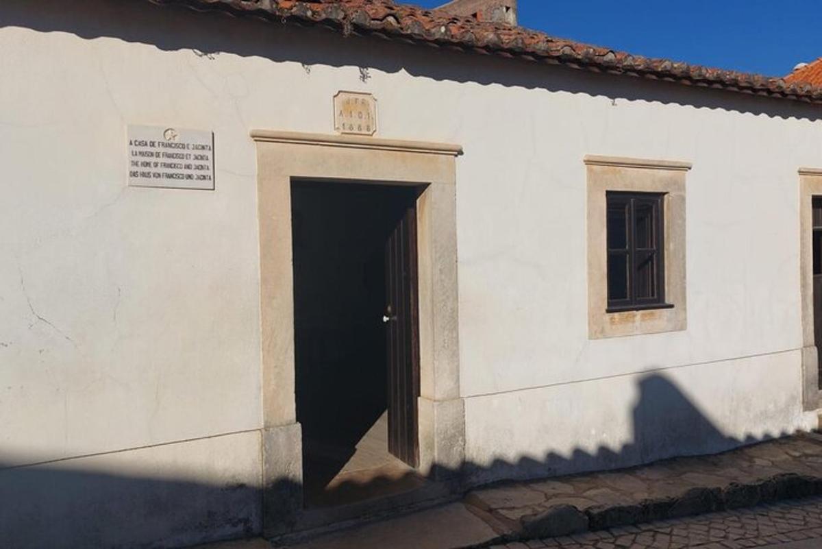 a white building with a door and a window
