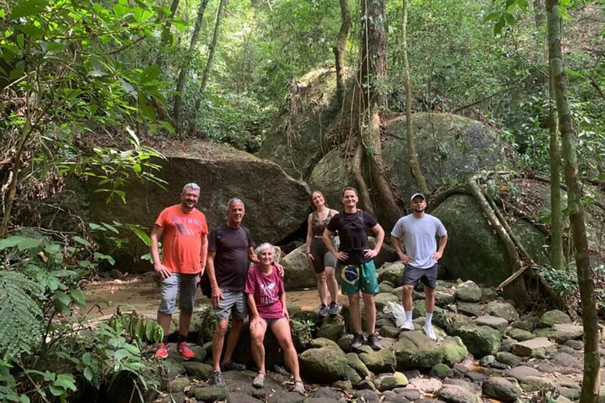 a group of people standing on rocks in a forest