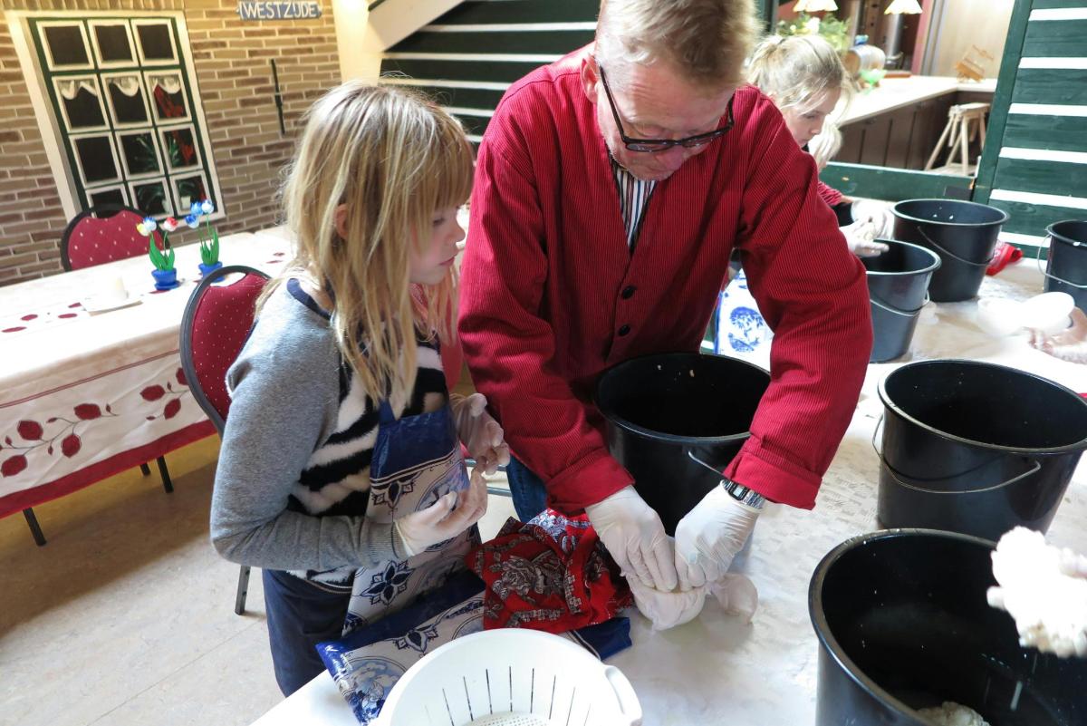 a man and a young girl are working on pot plants