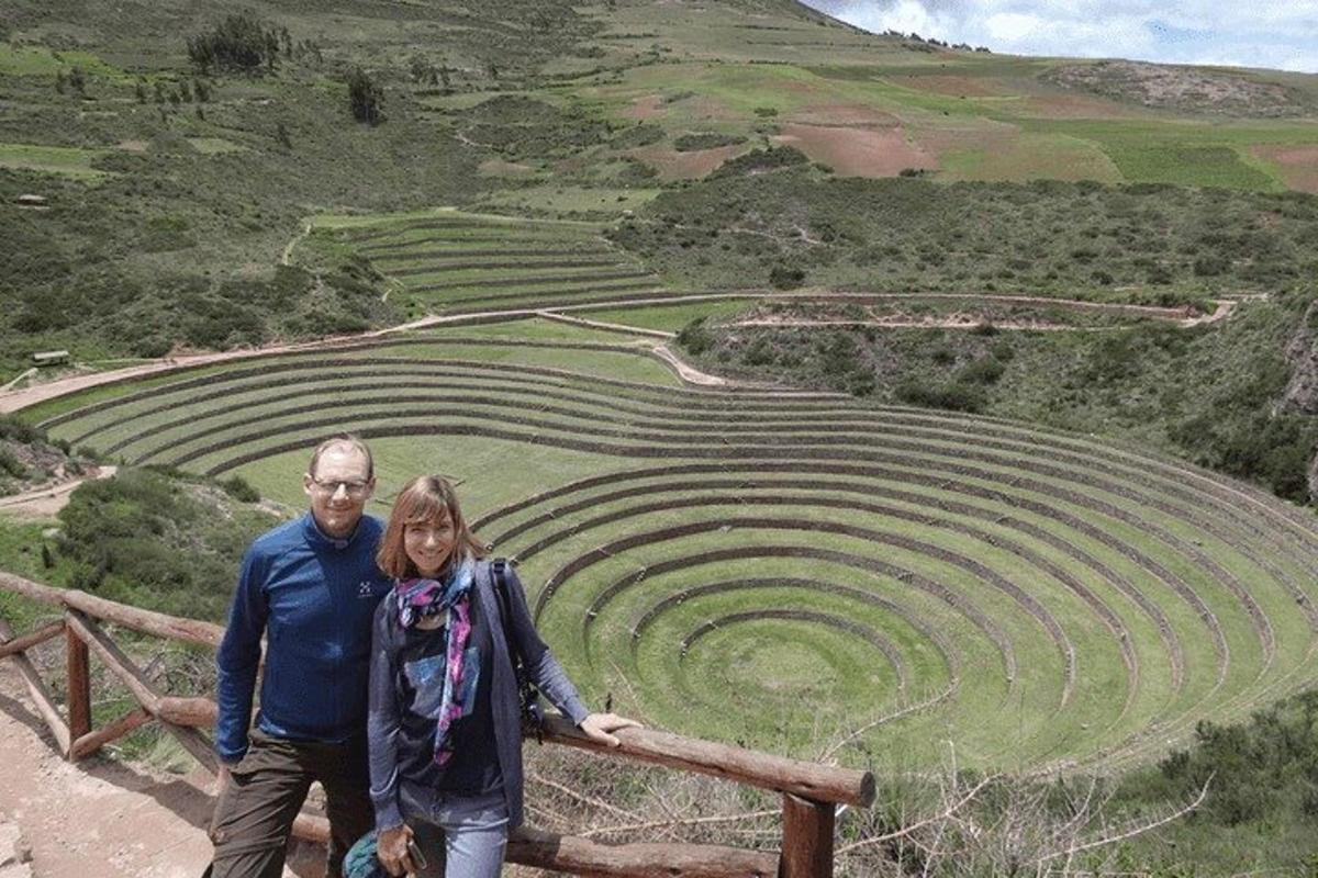 a man and woman standing in front of an amphitheater