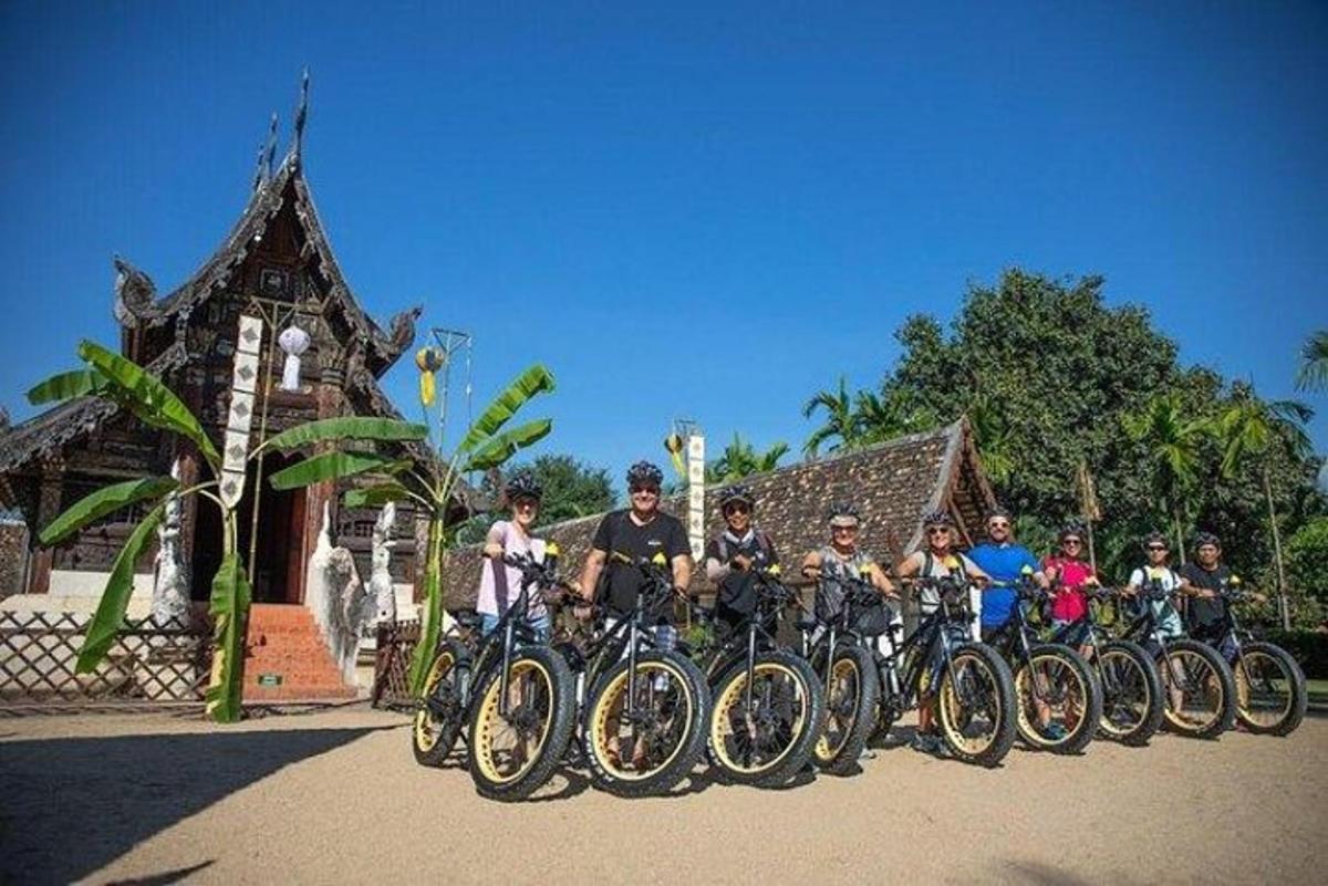 un gruppo di persone che posano per una foto con le loro biciclette