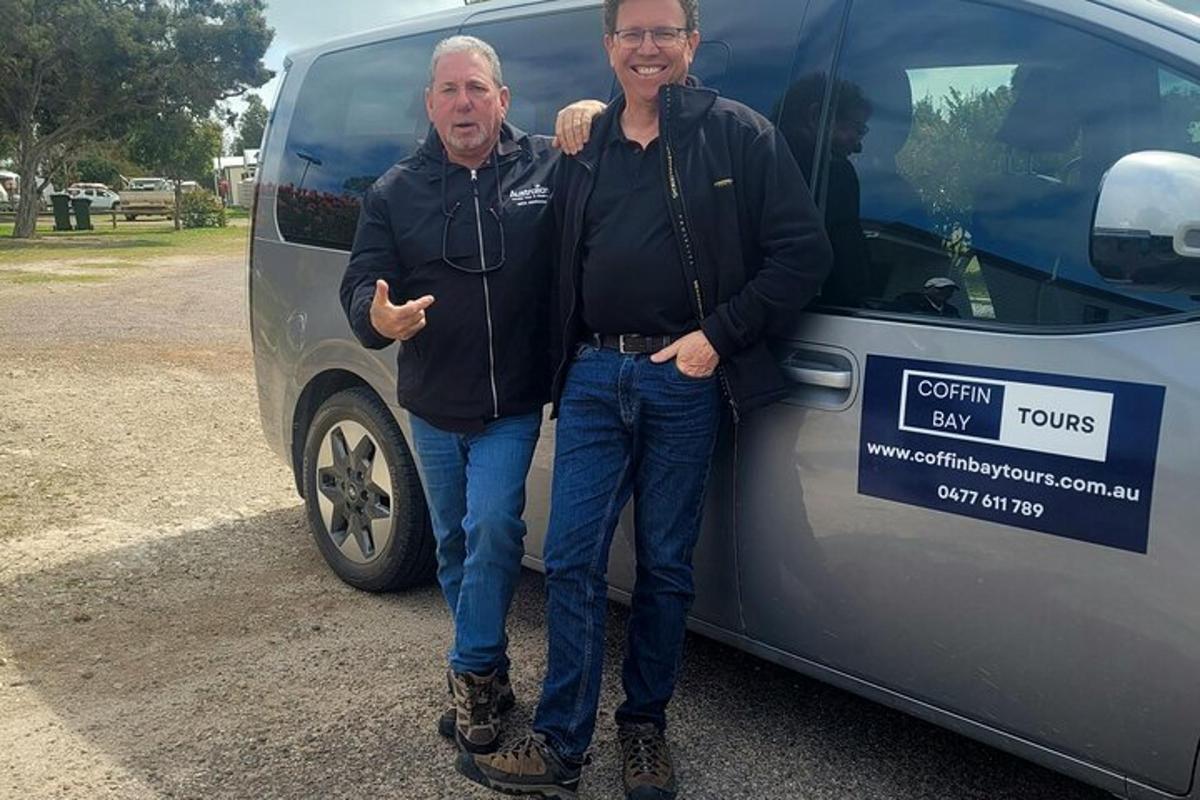 two men are standing in front of a van