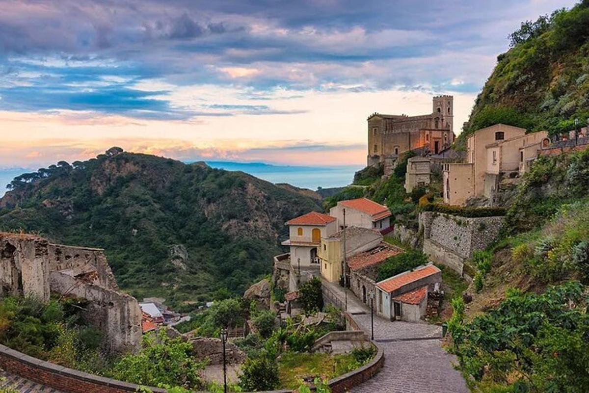 a village on a hill with a castle in the background