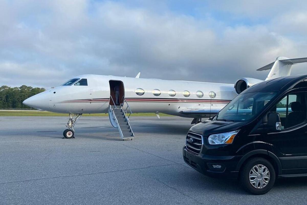 a car parked next to a plane on a runway