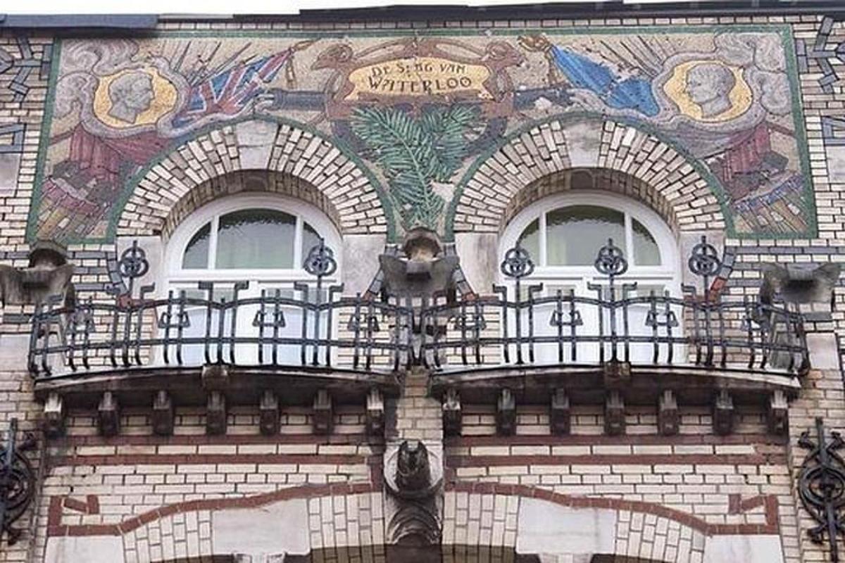 a building with two windows and a mural on it