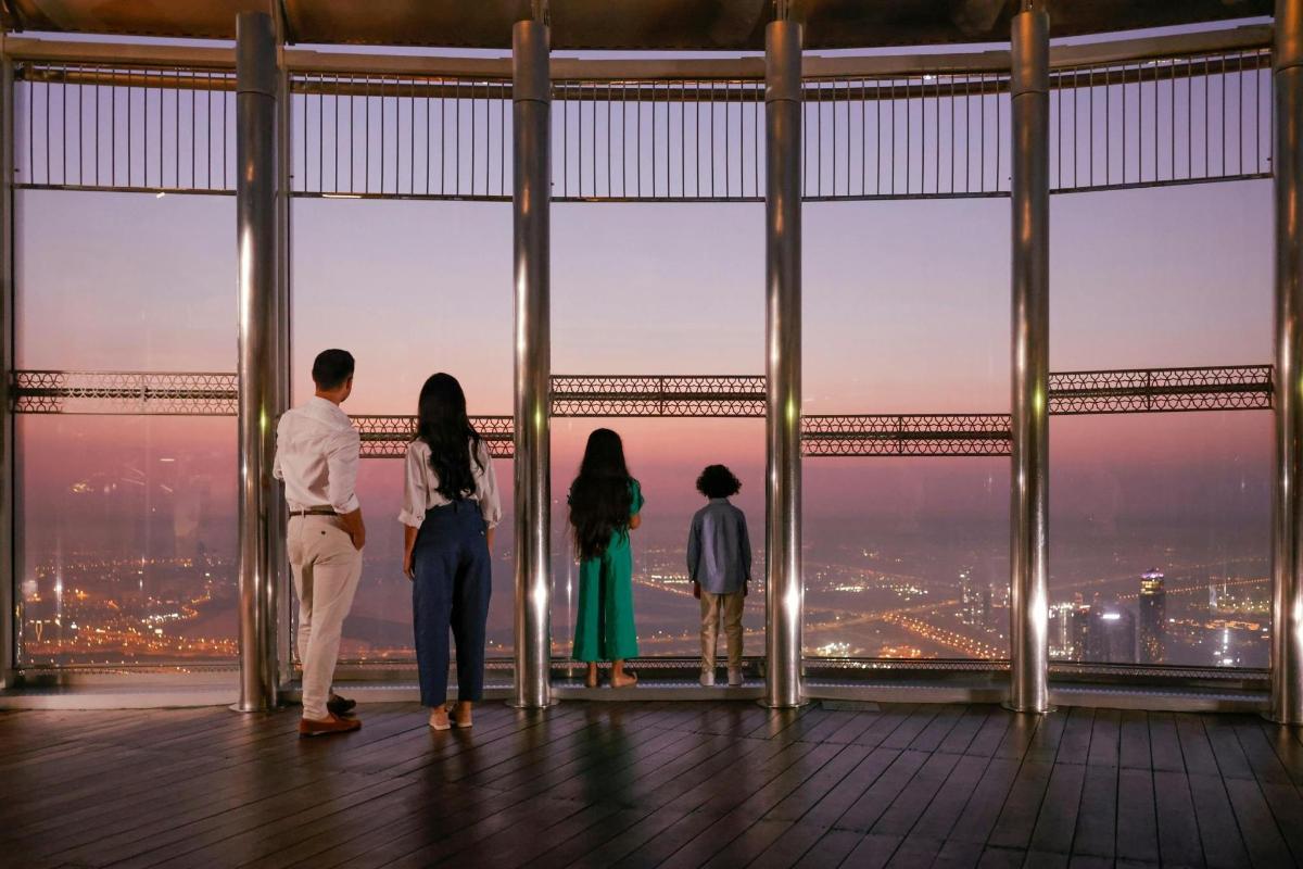 a group of people looking at the city from a tower