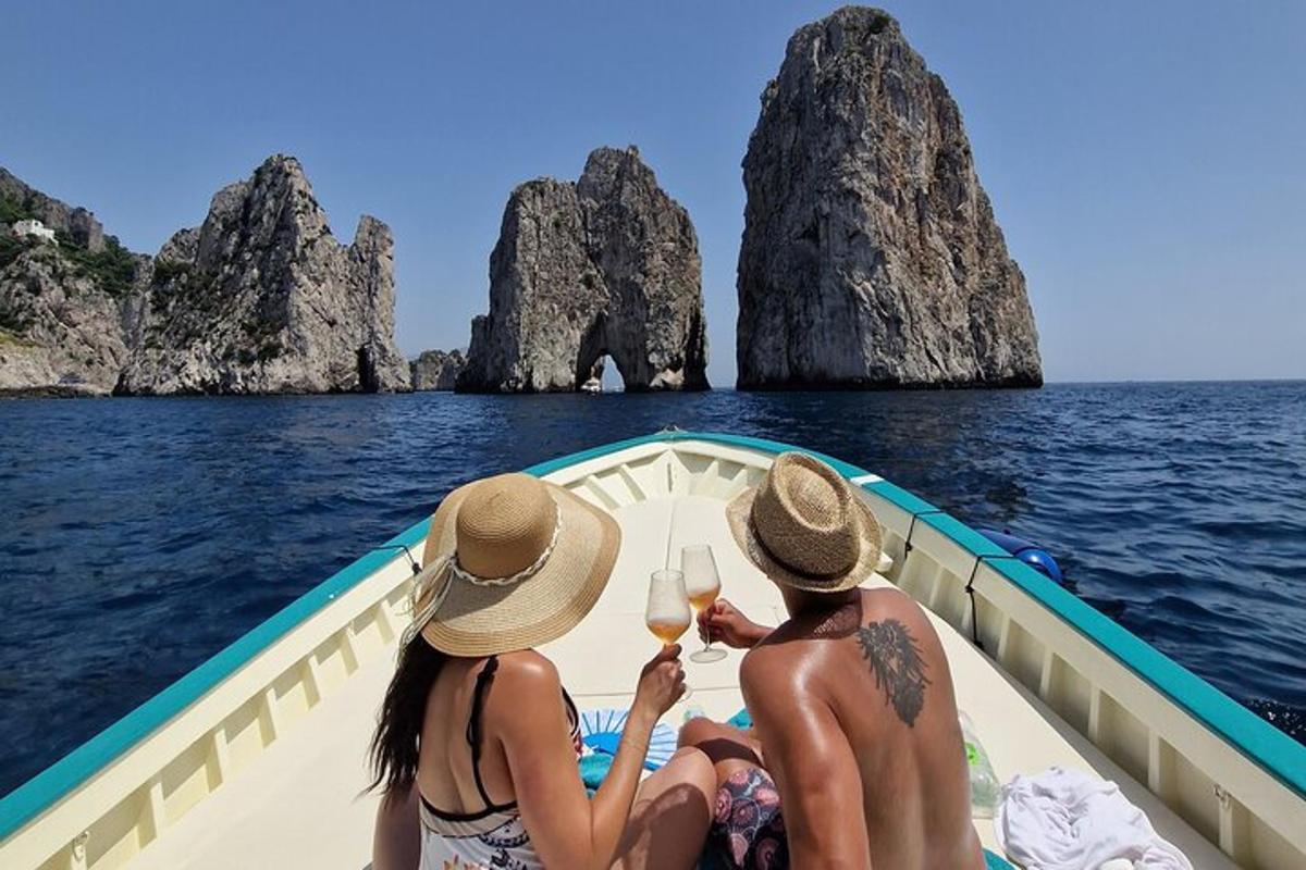 three people sitting in a boat with glasses of wine