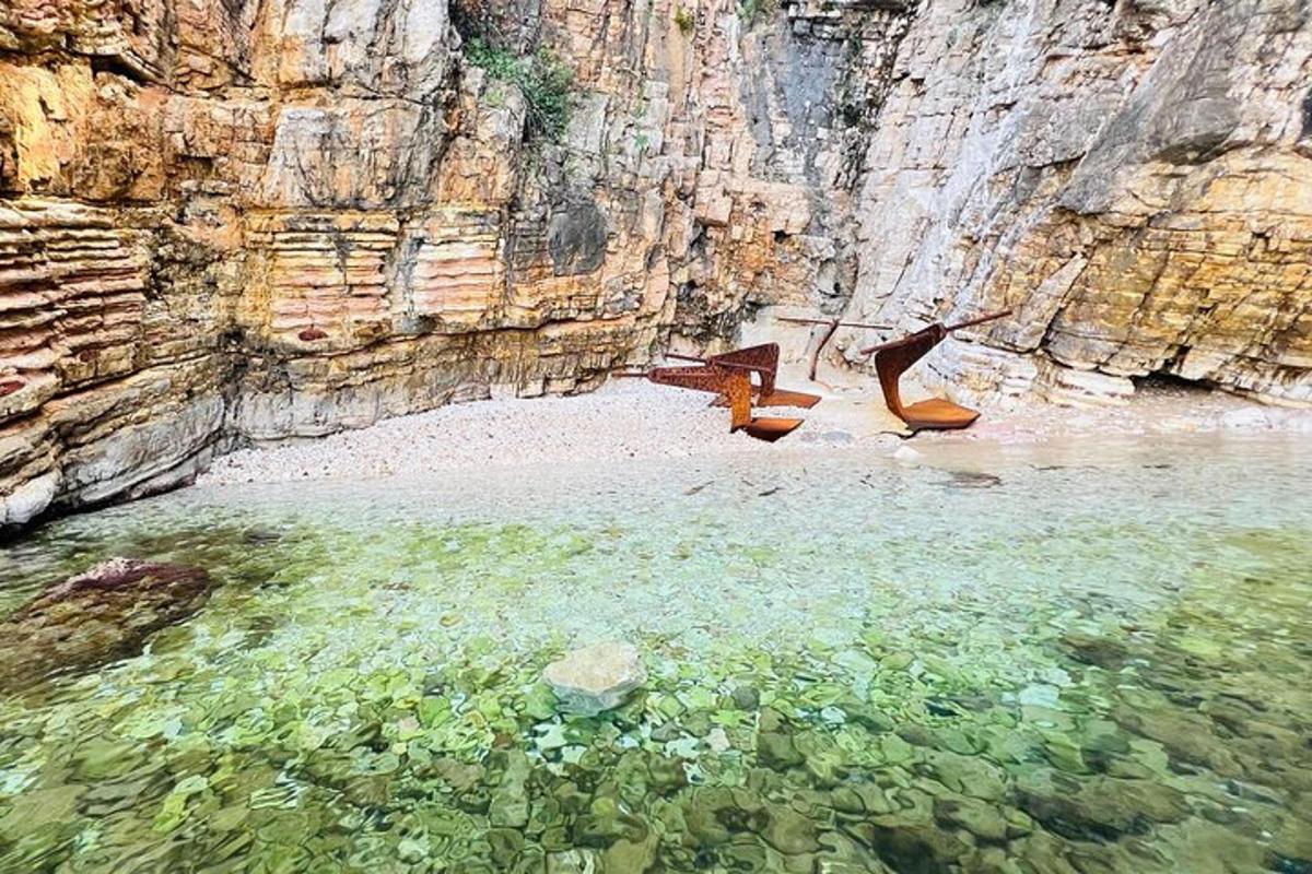 two shoes are in the water next to a cliff