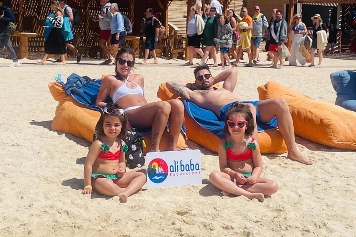 a group of people sitting on the beach