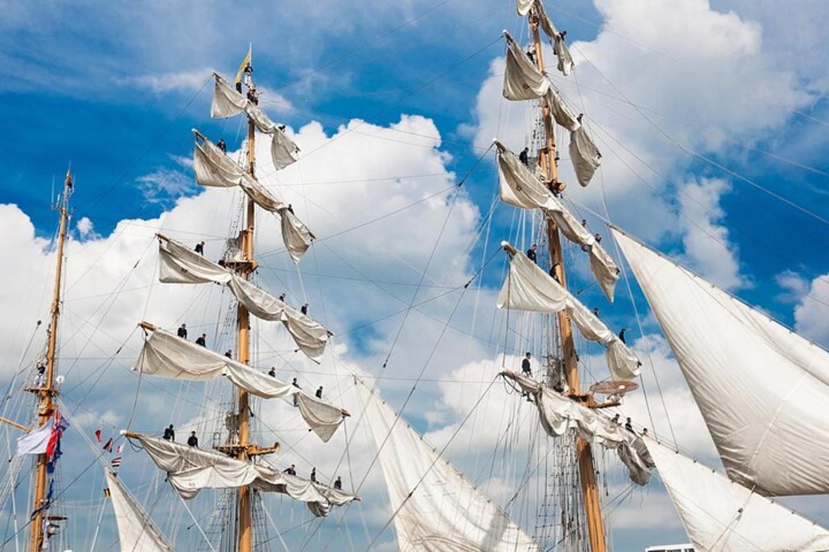 a group of white sails on a tall ship