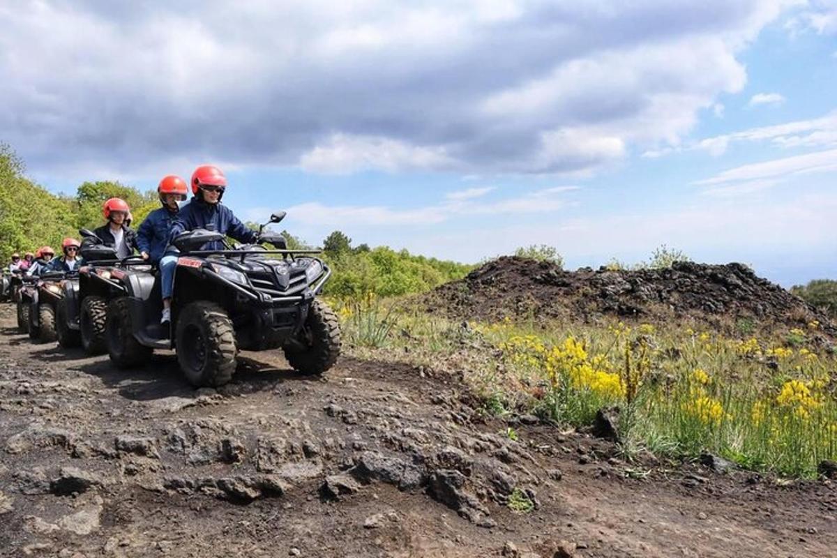 a group of people riding on atvs on a dirt road