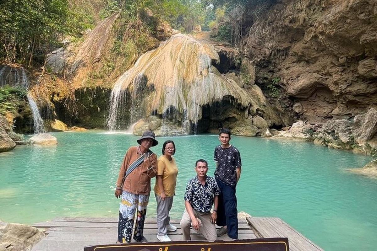 sekumpulan orang berdiri di hadapan air terjun
