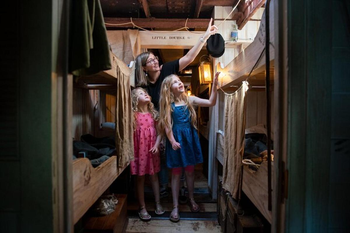 a woman and two little girls standing in a room