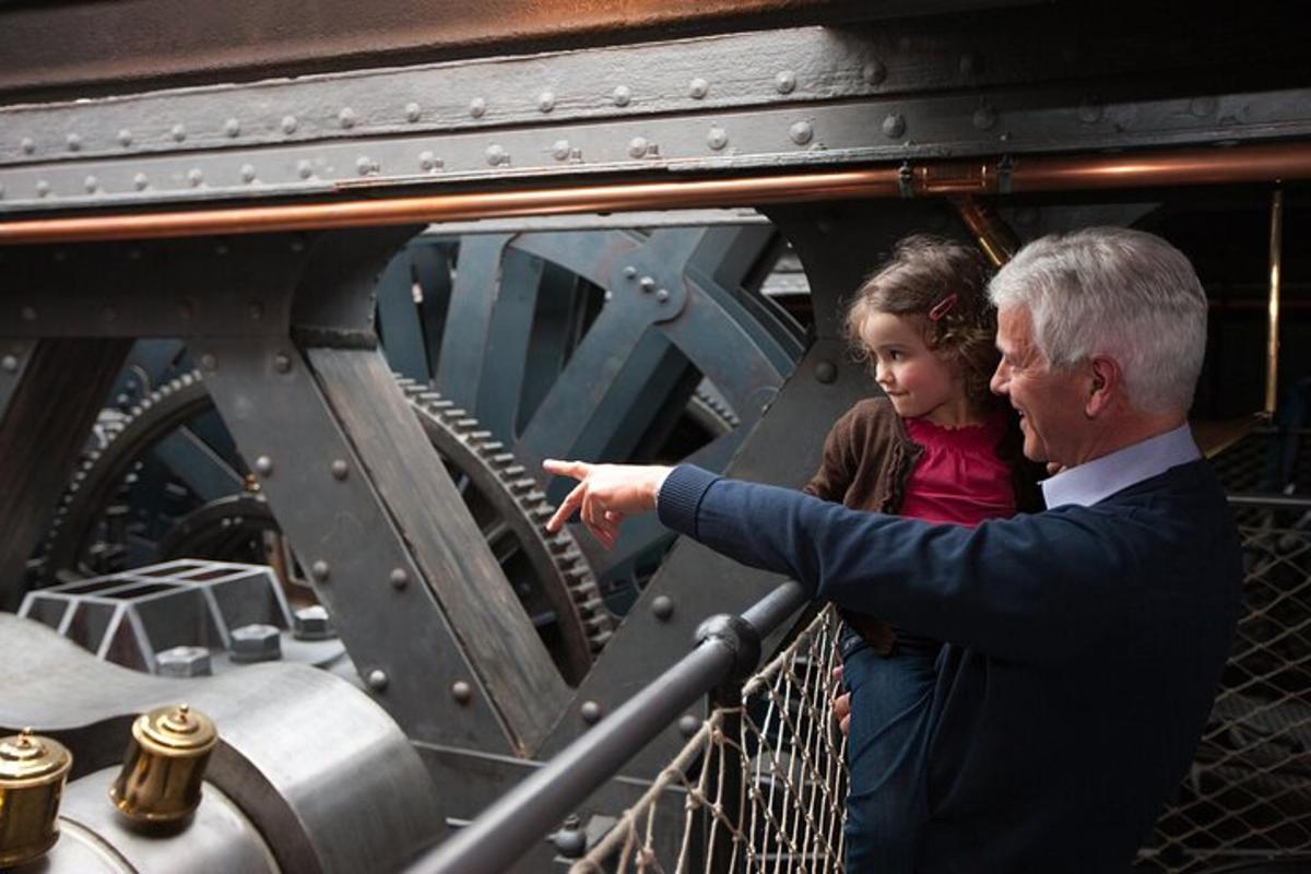 a man pointing at a little girl in a machine