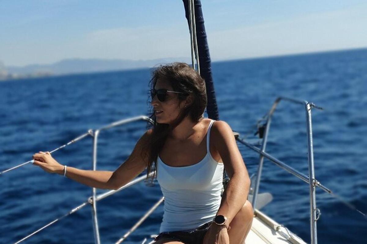 a woman sitting on a boat in the ocean