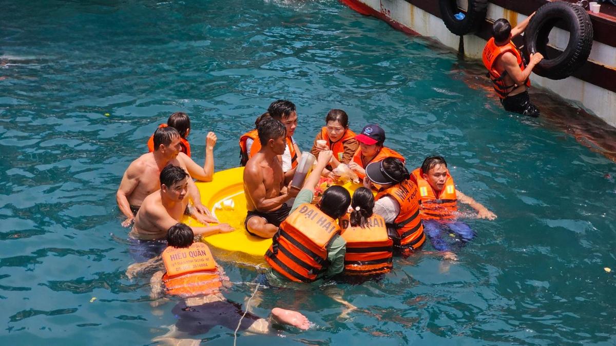 a group of people in the water on a raft