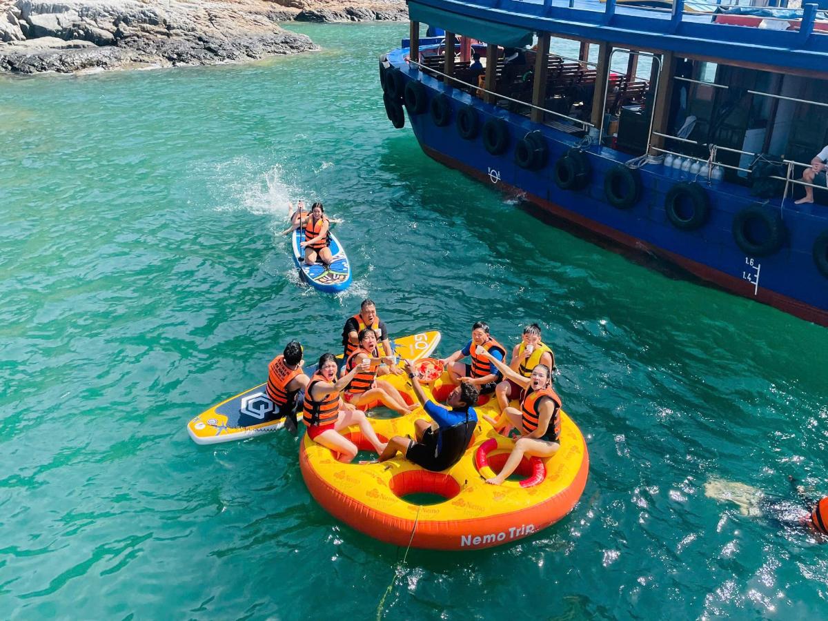a group of people riding on an orange raft in the water
